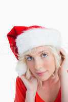 Young blonde woman wearing the Santa Claus hat