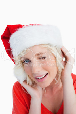 Young woman wearing Christmas clothes while blinking an eye