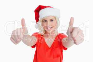 Smiling young woman putting her thumbs up in satisfaction