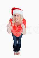 Fair-haired woman putting her thumbs up while wearing Christmas