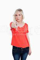 Serious blonde woman pointing her finger