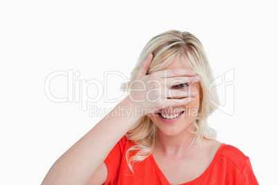 Young woman trying to see through her fingers placed in front of