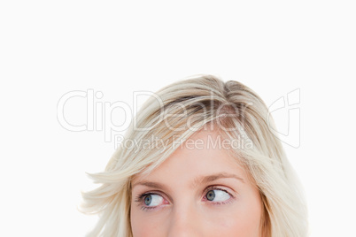 Upper part of a blonde woman face looking on the side