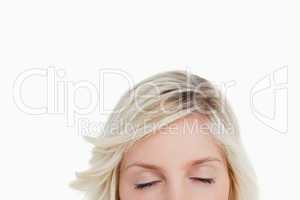 Woman closing her eyes while hiding the lower part of her face