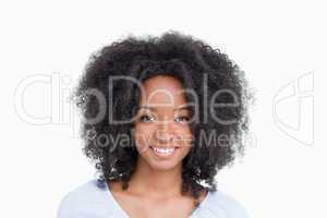 Young woman with curly hair standing upright