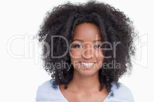 Young woman with curly hairstyle showing a great smile