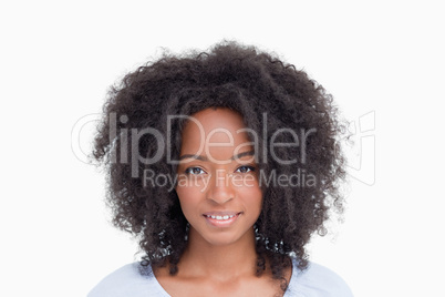 Young woman with curly hairstyle standing upright