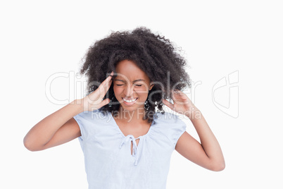 Young woman touching her temples while being angry