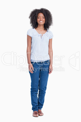 Young woman standing upright while showing a great smile