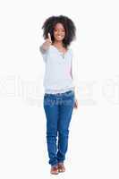 Young woman showing a great smile while placing her thumbs up