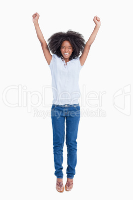 Young dynamic woman raising her arms above her head