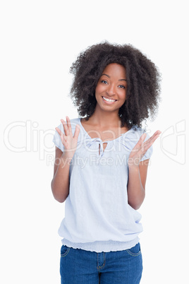 Young woman raising her hands as an indication of happiness