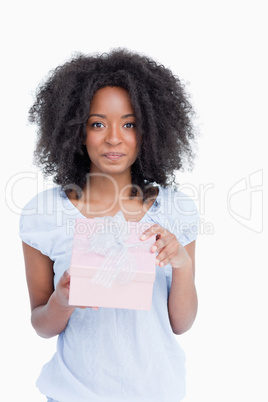 Young woman looking at the camera after opening her gift