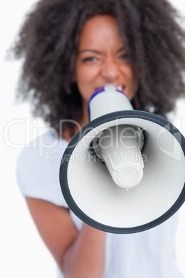 Megaphone held by a young woman shouting