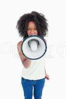 Angry young woman talking into a megaphone