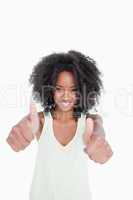 Relaxed young woman putting her thumbs up in satisfaction