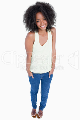 Smiling and relaxed woman putting her hands in pockets