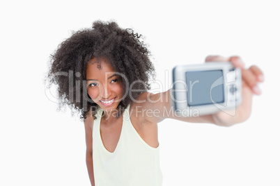 Smiling young woman photographing herself