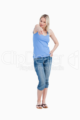 Relaxed blonde woman pointing her finger