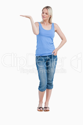 Blonde woman looking at her right hand palm up