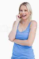 Blonde woman using a cellphone while laughing