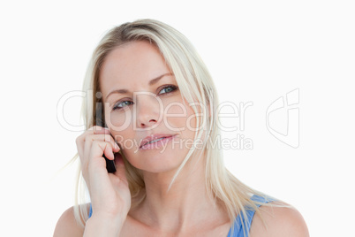 Blonde woman looking to the side while calling