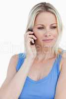 Relaxed blonde woman talking on her mobile phone