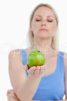 Beautiful green apple held by a blonde woman
