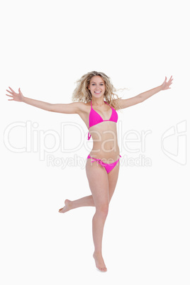 Smiling blonde woman opening her arms