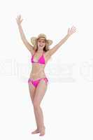Blonde teenager raising her arms while standing upright