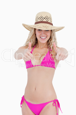 Smiling attractive teenager showing her two thumbs up