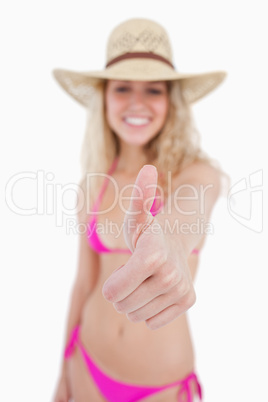 Thumbs up showed by an attractive smiling woman