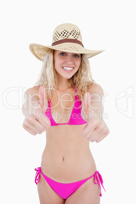Attractive teenager showing a great smile with her thumbs up