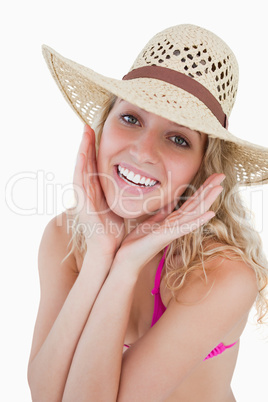 Teenager showing a great smile with her hands on her cheeks
