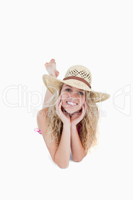 Smiling teenager wearing a hat while lying down