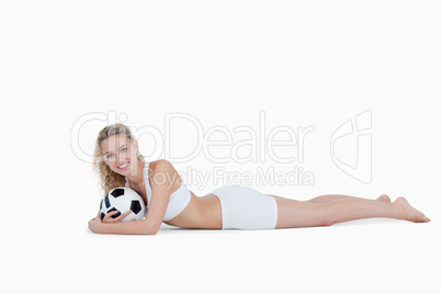 Smiling teenager holding a football close to her
