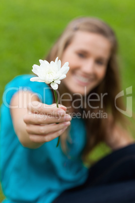 Beautiful white flower held by an attractive young woman