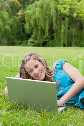 Young woman showing a great smile while lying on the side in a p