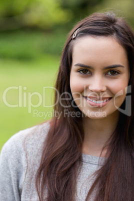 Young attractive woman looking straight at the camera while stan