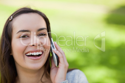 Young laughing woman showing her happiness while talking on the