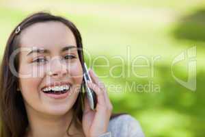 Young laughing woman showing her happiness while talking on the