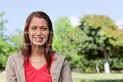 Young woman looking straight ahead with a smile on her face