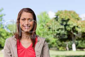 Young woman looking straight ahead with a smile on her face