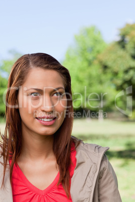 Woman looking towards the sky with the sun shining onto her face