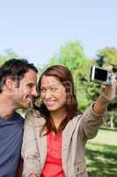 Young woman and her friend look at each other while she takes a