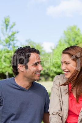 Two friends smiling as they look into each others eyes