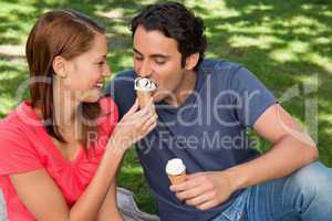 Woman feeding her friend ice cream