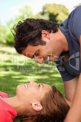 Man smiling as he looks down towards his friend