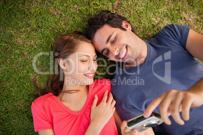 Two smiling friends looking at photos on a camera