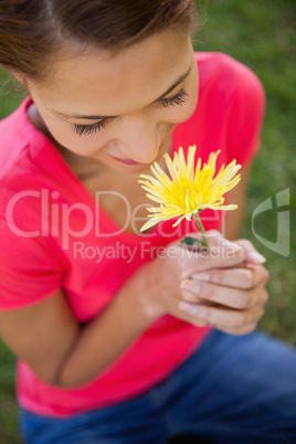 Woman smelling a yellow flower